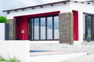 a house with a red door and windows at Vegas Guesthouse in Bushbuckridge
