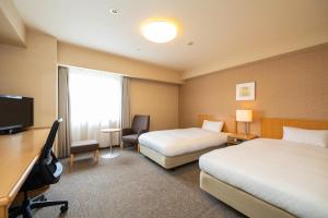 TV a/nebo společenská místnost v ubytování En Hotel Akita エンホテル秋田 + 10 fotografií