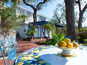 a table with a bowl of oranges on it at Villa Giovanna in Sorrento