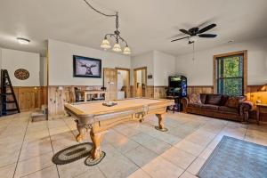 a living room with a pool table on a tile floor at Relaxation Retreat - Pickleball Cabin - Wi-Fi, Fire Pit with Bar, EV, Game Room, Hot Tub, Pool Access - Mins to PF in Sevierville