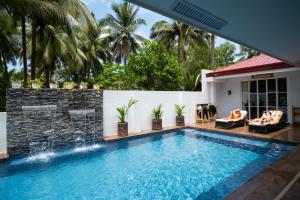 a swimming pool in a villa with a resort at Vida Homes Sipalay in Sipalay