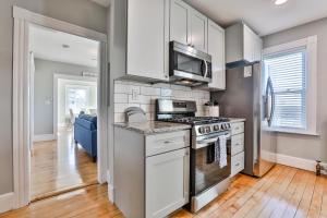 a kitchen with a stove and a microwave at Stylish Apartment Near Downtown, Highways, Boston in North Andover