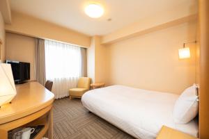 Postel nebo postele na pokoji v ubytování En Hotel Akita エンホテル秋田