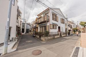 an empty street with houses on the side of the road at 華夏民宿 in Tokyo