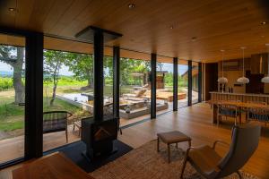 an open living room with a stove in a house at SONEKA in Kitahiroshima +98 photos