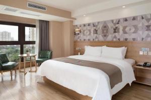 Кровать или кровати в номере PAI Hotels·Jiangbei Airport Central Park