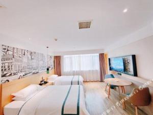 a hotel room with two beds and a table at City Comfort Inn Changsha Huangxing Avenue Airport Longhua Metro Station in Changsha +196 photos