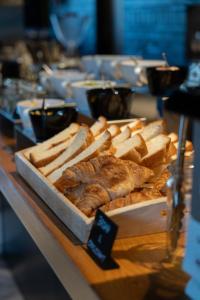 a buffet of bread and pastries on a table at Hotel She, Osaka in Osaka