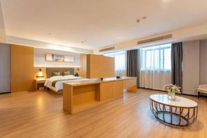 a hotel room with a bed and a table at Green Tree Inn Anhui Suzhou Evergrande in Suzhou +191 photos