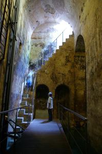 
a man walking down a stairway in a tunnel at Mont-Sant in Xàtiva

