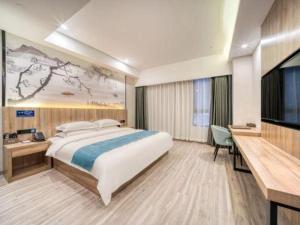 a hotel room with a large bed and a television at Gya Hotel Hangzhou Yuhang District Smart Town Wanda Plaza in Cangqian +130 photos