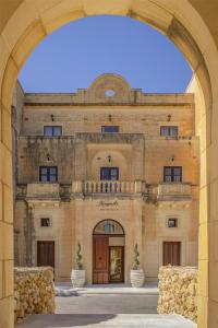 an entrance to a building with an archway at Kempinski Hotel San Lawrenz in San Lawrenz