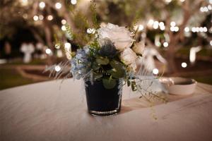 a vase filled with flowers sitting on a table at Kempinski Hotel San Lawrenz in San Lawrenz