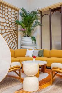 a living room with a couch and a table at Kempinski Hotel San Lawrenz in San Lawrenz