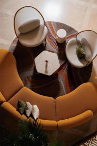 a living room with a couch and a table at Kempinski Hotel San Lawrenz in San Lawrenz