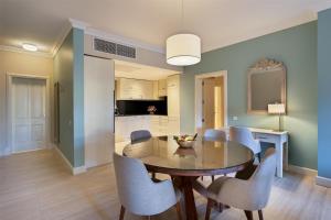 a dining room with a glass table and chairs at Kempinski Hotel San Lawrenz in San Lawrenz