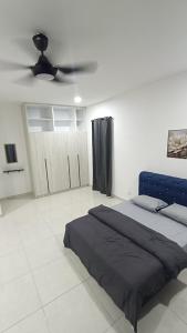 a bedroom with a bed and a ceiling fan at Aruna Retreat Rawang in Rawang +36 photos