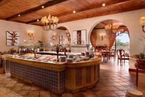 a kitchen with an island in the middle of a room at Kempinski Hotel San Lawrenz in San Lawrenz