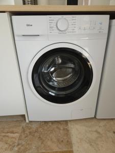 a white washing machine sitting under a counter at Havre de paix climatisé vers Gordes - Spa & nature in Beaumettes