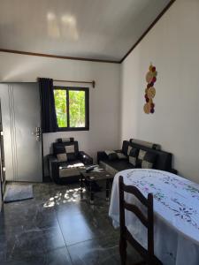 a living room with a bed and a couch at Seromue in Antsiranana