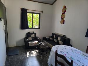 a living room with couches and a table and a window at Seromue in Diego Suarez +11 photos