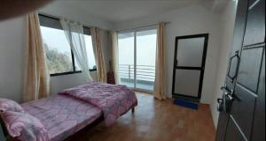 Postel nebo postele na pokoji v ubytování Dumfu Homestay