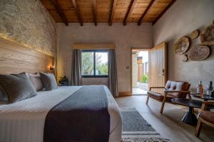 a bedroom with a large bed and a window at Casa Olivea in Valle de Guadalupe +57 photos