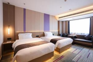 Postel nebo postele na pokoji v ubytování Lavande Hotel Nanchang West Station Guoti Center Metro Station + 94 fotografií