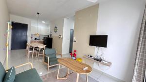 a living room with a couch and a table and a tv at SpongeBob lover Wi-Fi TV box in Cheras