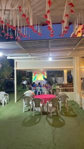 a group of people sitting at a table in a patio at GP Villa in Guntūr