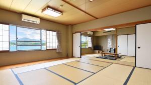 a living room with a large window and a table at Marine Hotel Harimo in Hamada +49 photos