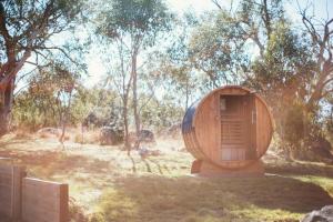 a wooden tub sitting in the middle of a field at Jillamatong House in Moonbah