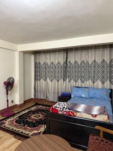 a bedroom with a bed with blue pillows at Thamel stay in Kathmandu