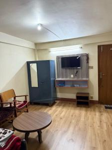 a living room with a table and a flat screen tv at Thamel stay in Kathmandu