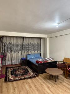 a bedroom with a bed and a table in it at Thamel stay in Kathmandu