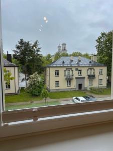 a view of a house from a window at Centro apartamentai in Biržai +3 photos