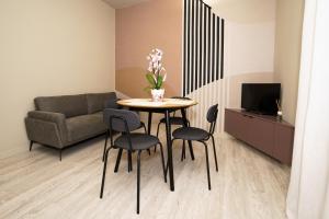 a living room with a table and chairs and a couch at Mario house Assisi in Assisi