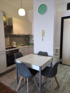 a kitchen with a white table and two chairs at Romantic Hillside Escape Sea View in Budva