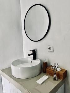 a bathroom with a white sink and a mirror at Volcano Garden in Kubupenlokan +53 photos