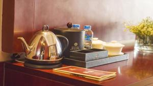 a tea kettle on top of a table at Grand Szechuan Hotel Vientiane in Vientiane