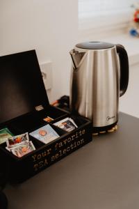 a tea kettle and a box on a table at Al Vicolo Holiday Home in Nave San Rocco
