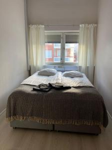 a bed sitting in a room with a window at Luxury City Apartments, Korkalonkatu in Rovaniemi