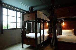 a bedroom with two bunk beds and a window at Rider bedroom hostel & cafe in Hua Hin