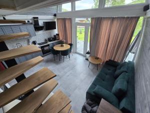 a living room with a blue couch and a table at Black Dora in Yaremche
