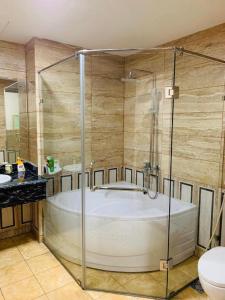 a bathroom with a bath tub and a toilet at Bacninh Charming Hotel in Bắc Ninh