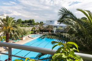 a view of a pool from the balcony of a resort at Hotel Cormoran in Cattolica