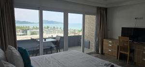a bedroom with a bed and a view of the ocean at Andaman Seaview house rooftop in Patong Beach