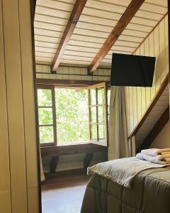 a bedroom with a bed and a window in a room at Complejo de Bungalows del Lago Km13 in San Carlos de Bariloche +20 photos
