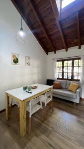 a living room with a table and a couch at Complejo de Bungalows del Lago Km13 in San Carlos de Bariloche