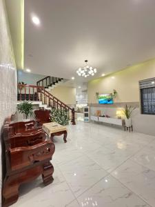 a large lobby with a staircase and a large room at Villa 26-28 Châu Đốc in Chau Doc